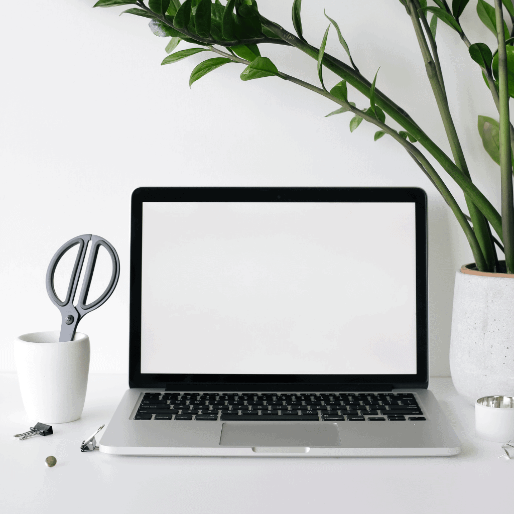 Laptop on a desk with the screen open.